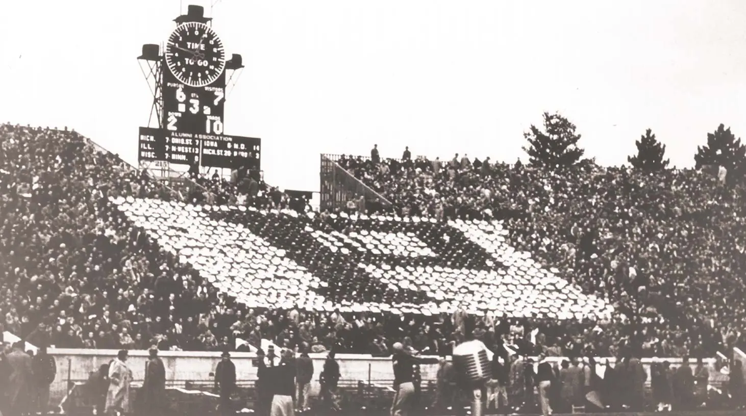 Fans in the stands of the stadium forming a 'p'